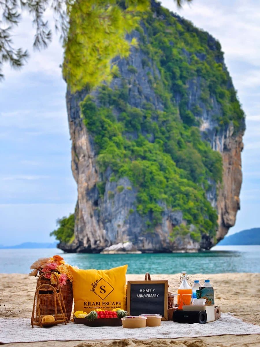 Anniversary beach picnic with a Krabi Escape cushion in front of Poda Island