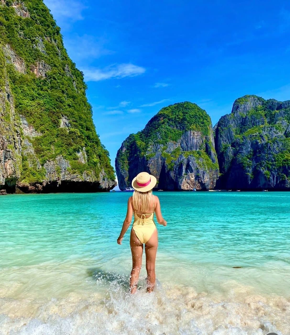 Guest wading into the turquoise water of Maya Bay, Phi Phi Islands
